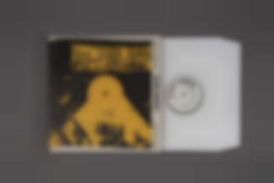 Grey background with album cover on top. The cover is black with some yellow elements. At the top, there is a yellow banner with text in black. 