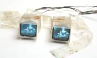 Artistic installation made up of two small TVs connected to each other by a see-through plastic-like material.
