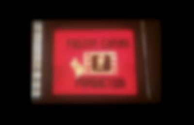 Red square with letters in black, reading: 