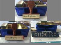 On top of a grey background, three different photographs show three different stamps in front of the same blue box. The stamp at the top reads 
