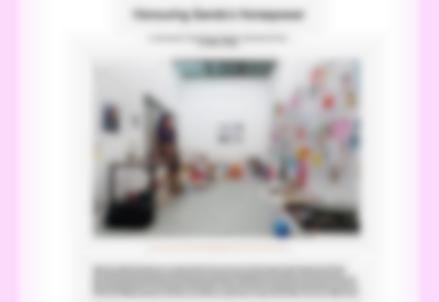 White page with a large photograph in the middle. The photograph shows an indoor space. On the left, there is a person with long hair sitting on top of a table. They face the opposite wall, which is full of drawings and hand-drawn posters. There are bags and others objects and materials on the floor, next to the walls. Above the photograph, large black text reads: 