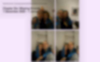 Pink page with four photographs. These photographs show the same two people posing for the camera, in selfie pose. They have a scarf wrapped around them. The photograph was taken in an indoor space. A ladder is partially visible on the two photographs at the bottom. On the top left corner, large black text reads: 