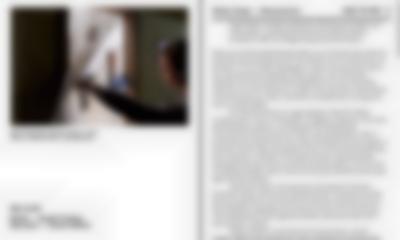 White page divided in two.; with a photograph on the left side and text in black on the right. The photograph shows a person opening a curtain to an indoor space. They are wearing headphones and hold a small monitor.
