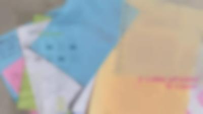 Several colourful sheets of paper with handwritten notes have been loosely stacked. A digital page with text and images has been superimposed on the image. On the bottom right, 