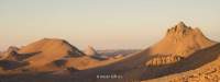 Arid area with sandy hills. A subtitle reads: 