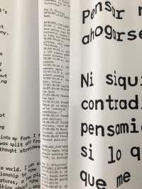 Three hanging pieces of fabric have black text printed in different sizes.