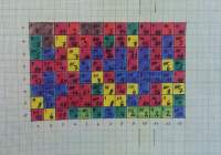 Square paper with squares hand-painted in different colours. Each square has a number inside.