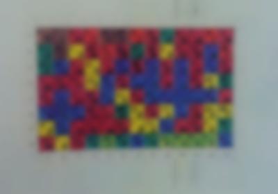 Square paper with squares hand-painted in different colours. Each square has a number inside.