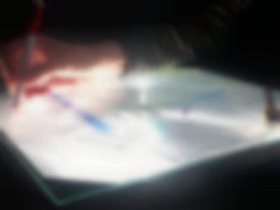 On top of a overhead project's stage, someone is making notes in red on a piece of glass. Underneath it, there is a printed text.